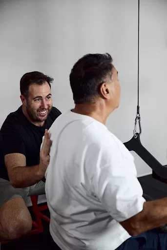 Osteopath helping a patient manage and recover from a gym-related injury